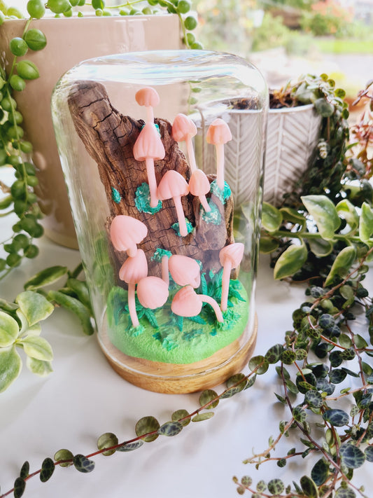 Pink mycena mushrooms on wood sculpture