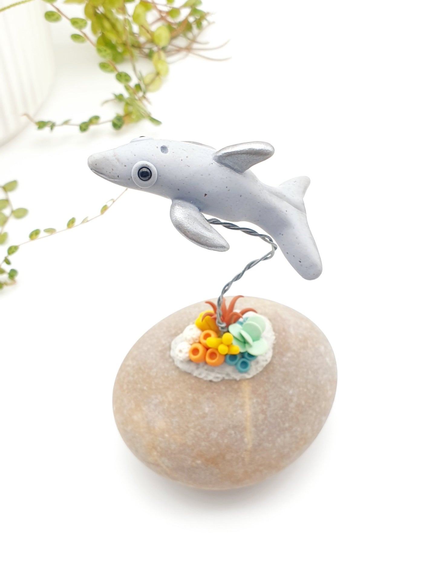 Dolphin & coral sculpture on rock