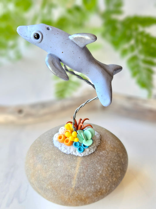 Dolphin & coral sculpture on rock