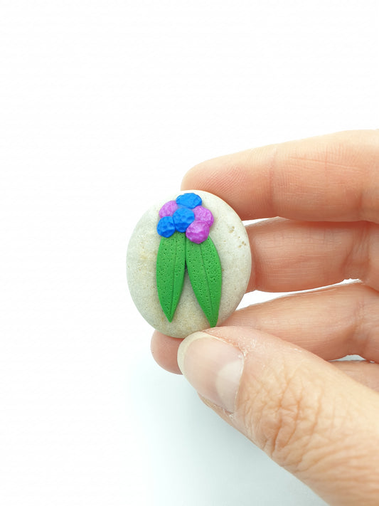 Gratitude rock with purple & blue blossoms