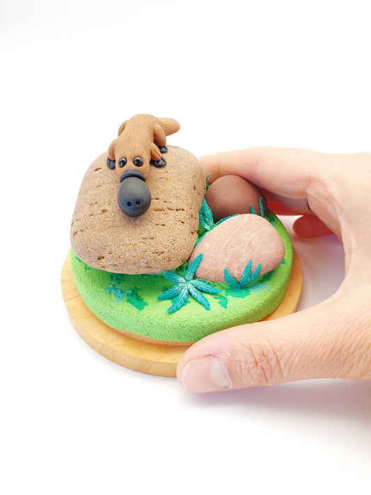 Platypus on rocks sculpture in glass cloche