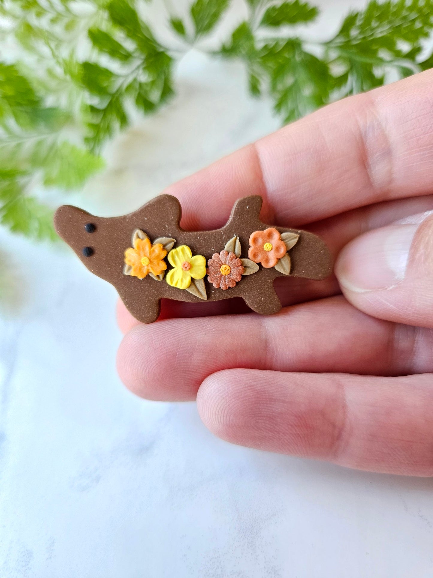 Platypus brooch with flowers