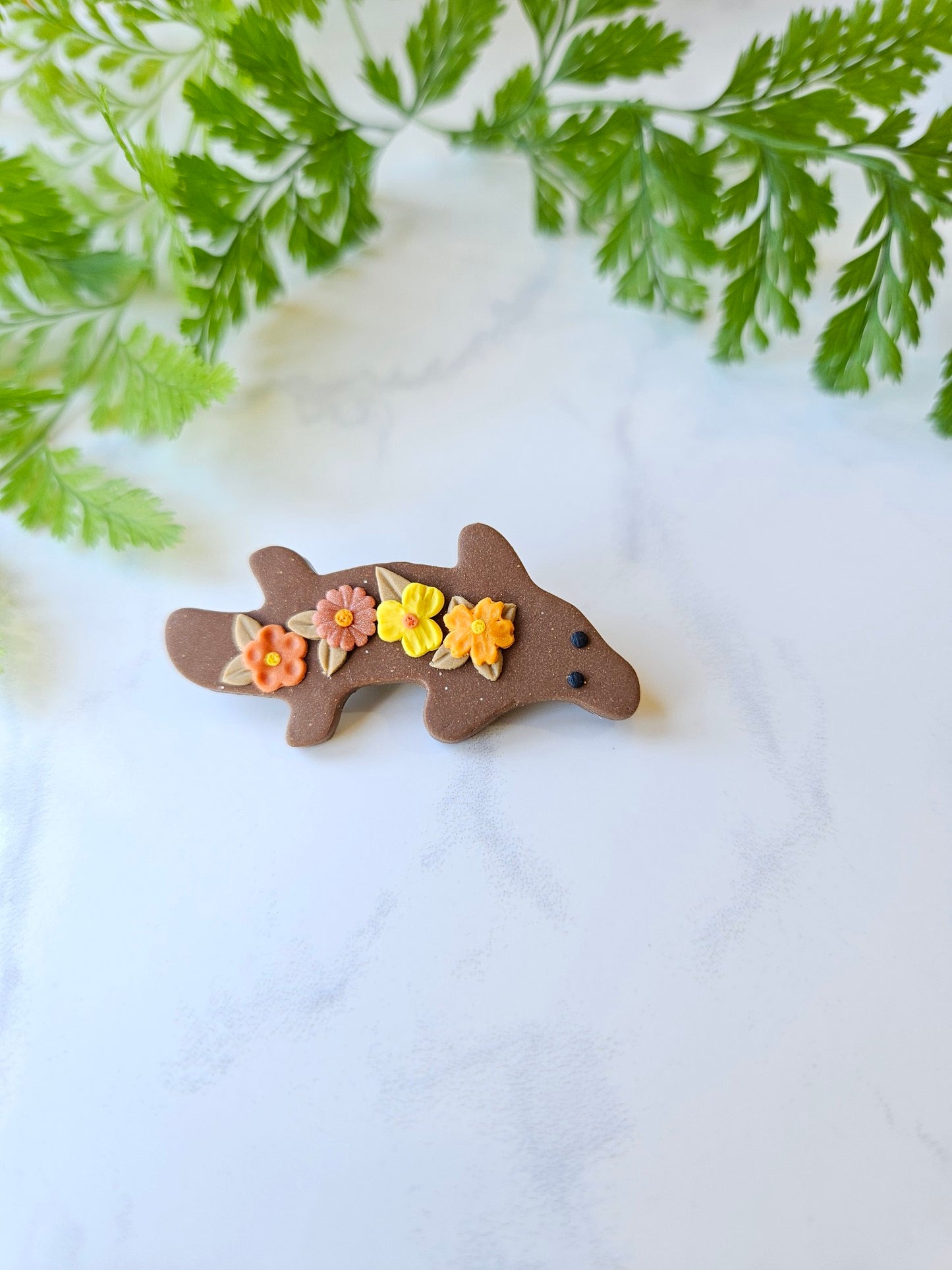 Platypus brooch with flowers