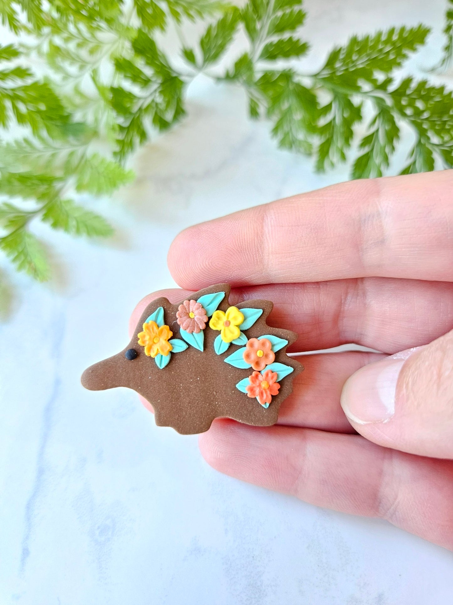 Echidna brooch with flowers
