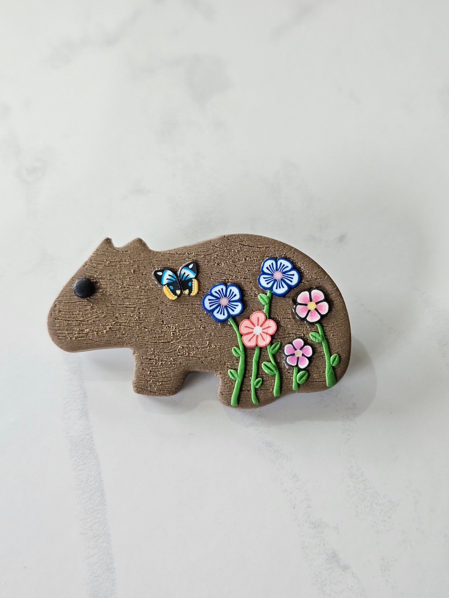 Wombat brooch with wildflowers