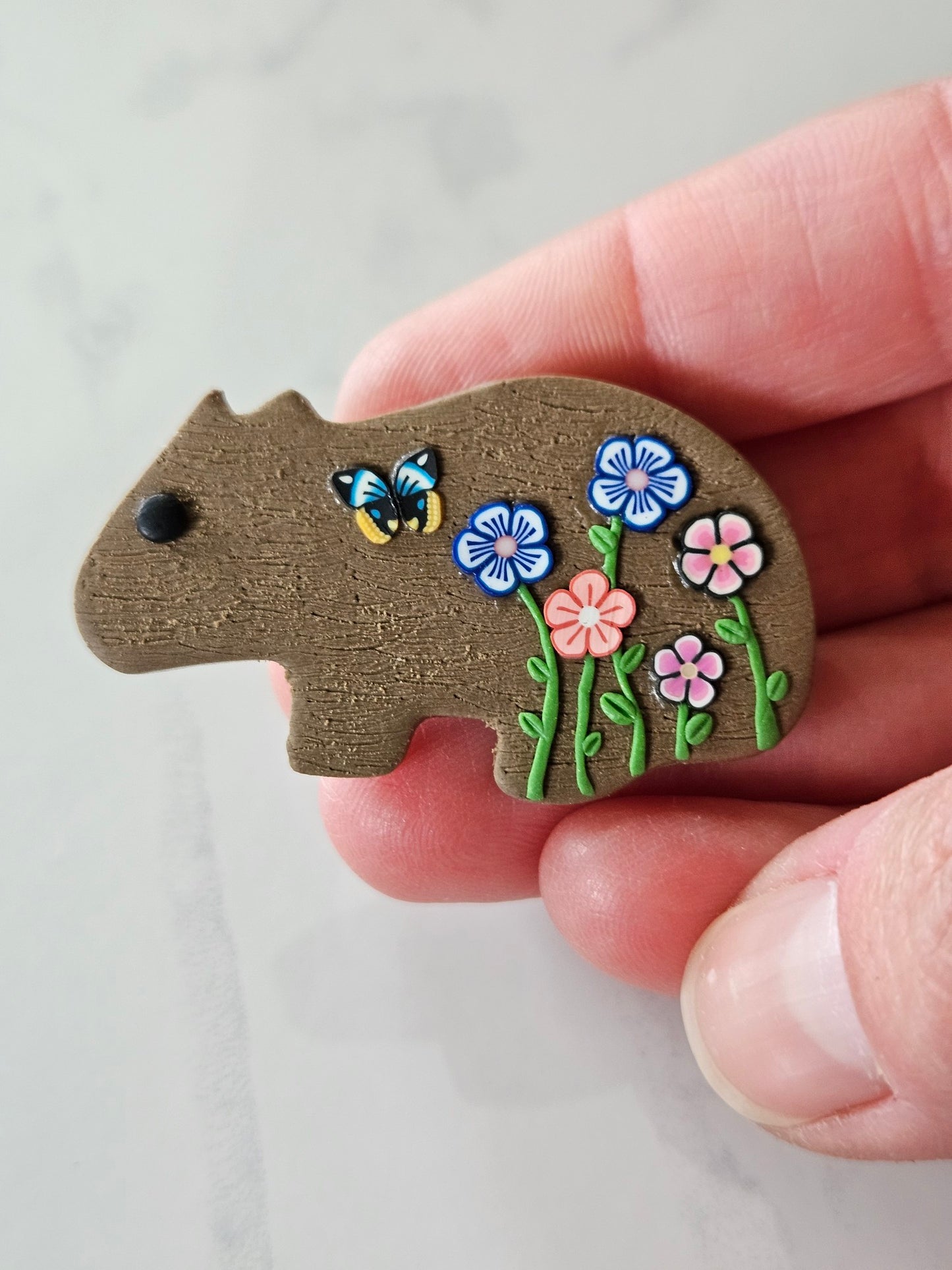 Wombat brooch with wildflowers