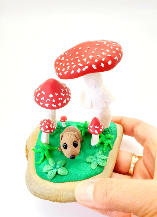 Saffy the miniature wombat sculpture is so tiny that she can fit underneath these super cute amanita mushrooms.