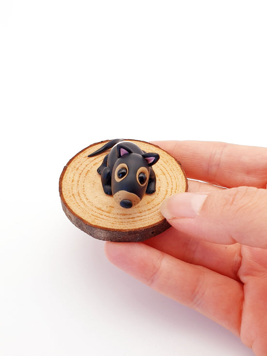 Polymer clay miniature Tasmanian devil sculpture. Hand made with incredible detail. Adorable, cute Australian native Tasmanian devil animal sculpture on a real wood slice