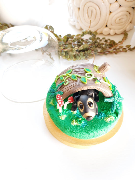 Polymer clay miniature Tasmanian devil sculpture in glass cloche cover. Hand made with incredible detail. Adorable, cute Australian native Tasmanian devil animal sculpture surrounded by sculpted ferns, mushrooms and forest plants.
