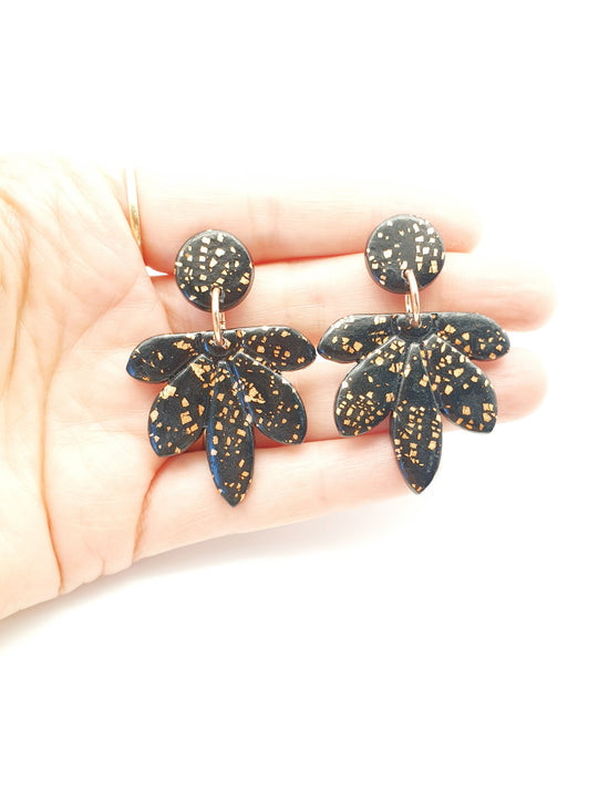 Hand made beautiful botanical polymer clay earrings. Shiny black blossoms with copper foil embedded into the clay with a crackle design.