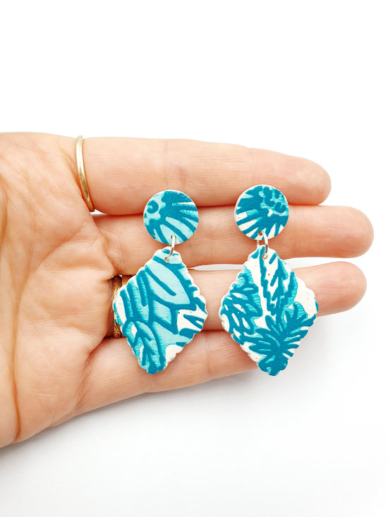 Hand made beautiful botanical polymer clay earrings. Turquoise leaves are screenprinted over the top of white granite clay