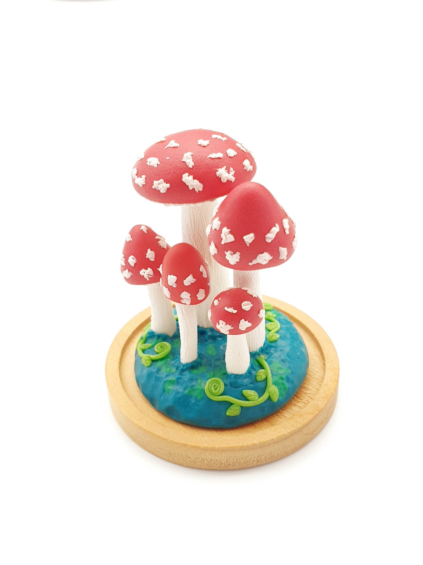 Miniature amanita mushroom sculpture in glass cover