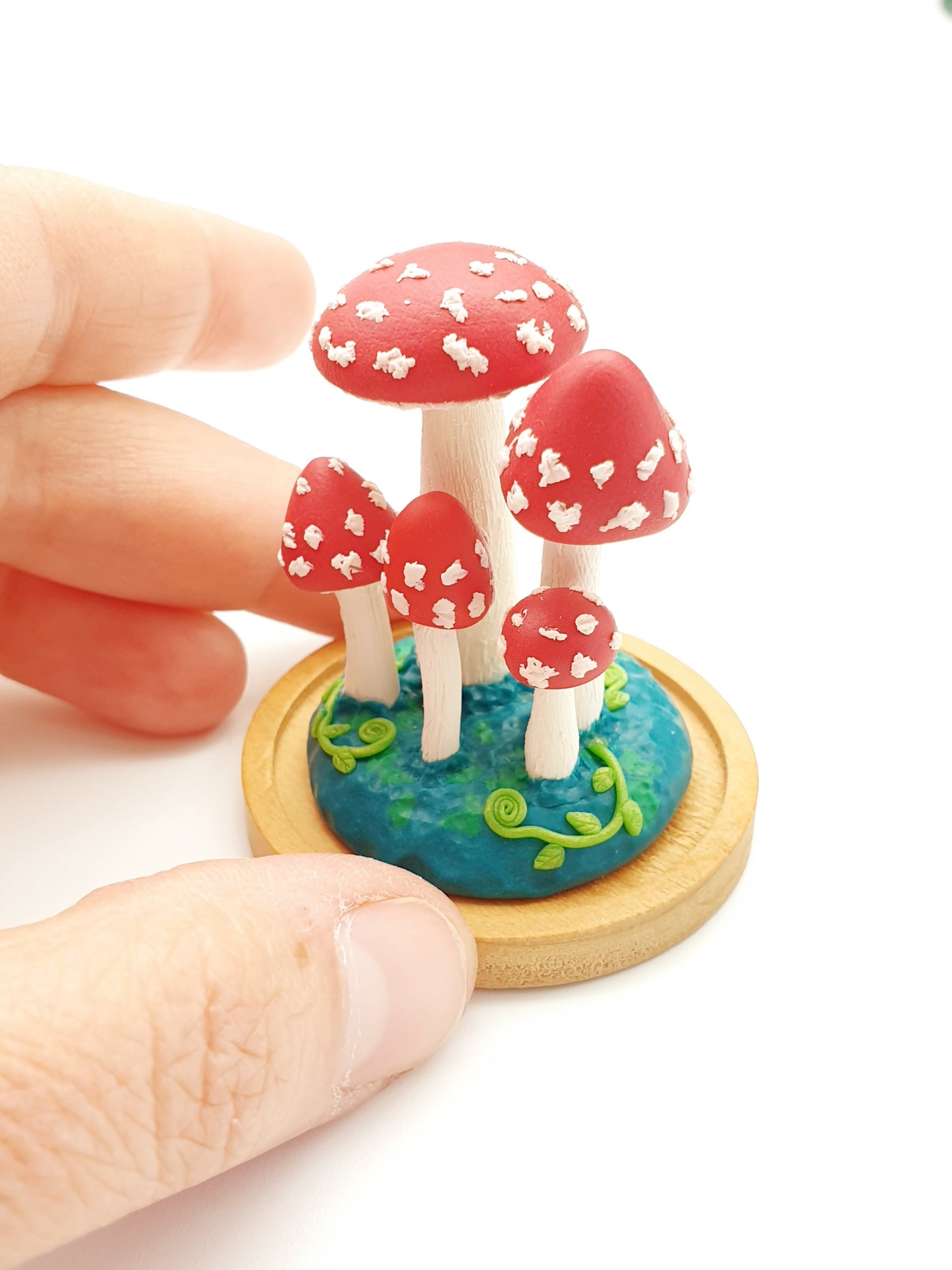 Miniature amanita mushroom sculpture in glass cover